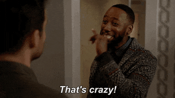 TV gif. Lamorne Morris as Winston on New Girl shakes his pointing pinky at someone off screen as he smiles and says, "That's crazy!"