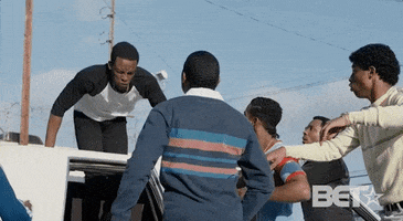 TV gif. In the mini-series The New Edition Story, Woody McClain, as Bobby Brown jumps out of the sunroof of a limo to fight Bryshere Gray as Michael Bivens as their friends look on, the men take the fight to the ground as Bobby tackles Michael.