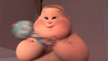 Movie gif. A giddy Jimbo from Boss Baby claps and shakes his fists excitedly while holding a rattle.