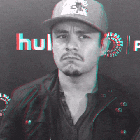 Celebrity gif. Jesse Garcia strokes his chin, glancing pensively from side to side.
