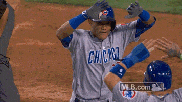 Sports gif. Chicago Cubs baseball players high five each other with both hands in slow motion.