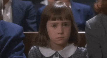 Movie gif. Mara Wilson as Susan in "Miracle on 34th Street" sits on a bench and shakes her head and rolls her eyes, then looks up at the adult sitting next to her.