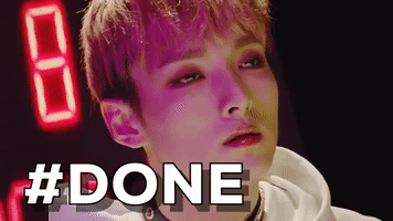 Video gif. A K-pop star bathed in pink light makes a flat expression, fed up. Text, "#done."