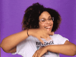 Video gif. Girl wearing a Beyonce shirt smiles and dances, waving her arms in front of her and dipping.