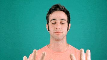 Celebrity gif. Charlie Singer bows his head and brings two overly large hands to his forehead for a facepalm.