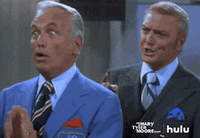 TV gif. Ted Knight as Ted Baxter on The Mary Tyler Moore Show looks at someone with big enthusiastic eyes as he put his hands in a praying position. The man behind him has his eyebrows furrowed and looks concerned.