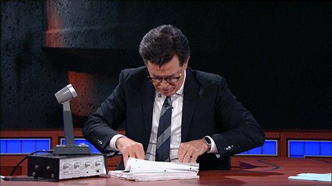 Gif of Stephen Colbert hurriedly looking through pages and pages of notes