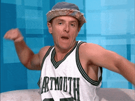 Reality TV gif. A contestant on Big Brother is wearing a jersey and a fedora and he does an air punch and says, "Boom!"