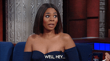 Celebrity gif. Regina Hall, on the Late Show with Stephen Colbert, leans back into the guest seat and tilts her head to the side, shrugging empathetically as she says, "well, hey," which appears as text.