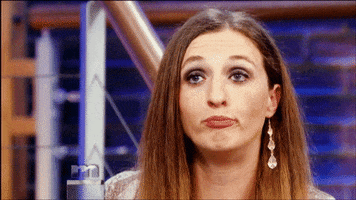 TV gif. A guest on the Maury Povich show purses her lips with some sass and tilts her head to the side as if totally unimpressed.