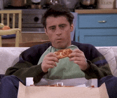 Friends gif. Matt LeBlanc as Joey sits on the couch with a box of pizza flung open between his legs. He holds a slice of pepperoni pizza and pauses in the middle of his bite to think hard about something. No thought can be found and he says with chewing, “I don’t know”