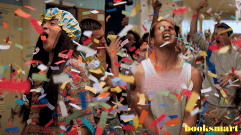 Gif of a group of people celebrating in a flurry of confetti