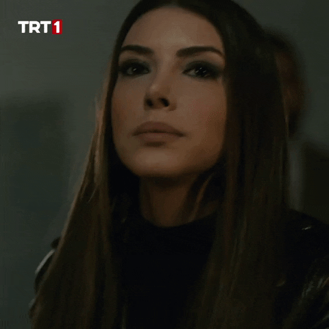 TV gif. Deniz Baysal as Zehra in Teşkilat. She cheers, jumps, and claps eagerly as she eats.