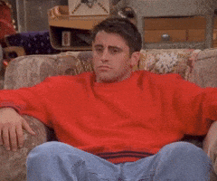 Friends gif. Matt LeBlanc is sunk into a cozy chair when his eyes grow wide; he looks to the left and to the right with shock.