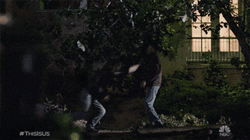 TV gif. On This is Us, teenage Randall and Kevin, played by Niles Fitch and Logan Shroyer wrestle to the ground in the dark.