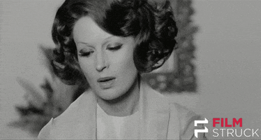 Movie gif. Silvana Mangano as Lucia in Teorema crosses herself with the Catholic gesture.