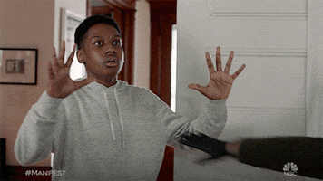 TV gif. In a scene from Manifest, a man steps in front of a scared boy, stopping a fight.