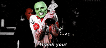 Movie gif. Jim Carrey dressed in a floral shirt with a green face as The Mask, holding onto what looks like an Oscar award, expressing over-the-top gratitude, shaking his head as he says "thank you!"