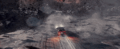 Movie gif. Two men in Moonfall yell in a car as it speeds off a crumbling cliff. They fly through debris and land on a floating rock. 