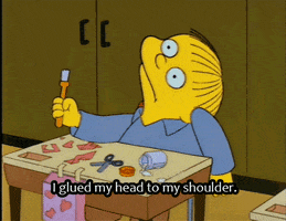 The Simpsons gif. Ralph sits at a school desk with miscellaneous arts and craft supplies scattered on his desk. His head is tucked to his shoulder and he holds a glue brush in his hand. He moves around in his seat. The text reads, “I glued my head to my shoulder.” 