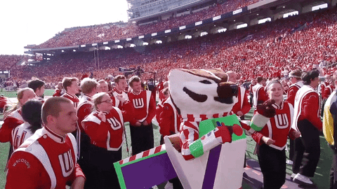 Bucky Badger, dressed as Buzz Lightyear, dancing with the UW Marching Band