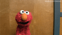 Tonight Show gif. Elmo from Sesame Street wobbles a bit before fainting.