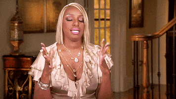 Reality TV gif. Nene Leakes from Real Housewives of Atlanta takes a deep breath, sighs, and slowly rolls her hands into fists, calming herself. 