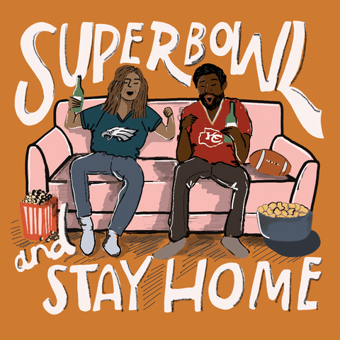 Text gif. Couple sitting on a couch, bottles in hand, snacks all around, the woman wearing a Philadelphia Eagles jersey, and the man wearing a Kansas City Chiefs jersey, as they both pump fists in celebration against an orange background. Text, "Super bowl and stay home."