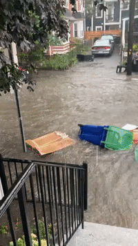 Recycling Bins Float Down Boston Area Street as Flash Flooding Hits