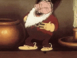 Cartoon gif. A dwarf with a white beard stands on a ledge next to a candlestick taller than him. He rocks back and forth holding his belly as he laughs in a continuous loop.