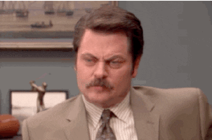 Gif of Ron Swanson from "Parks and Recreations" looking concerned, then shrugging like he doesn't care. 