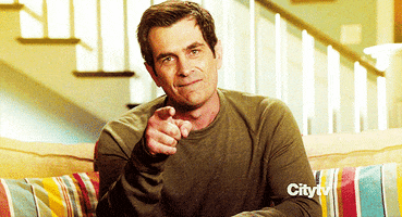 TV gif. Ty Burrell as Phil on Modern Family bites his lip as he gives a thumbs up, then points at us as he says, "Yeah."