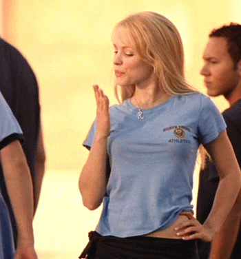 Movie gif. Among classmates in gym clothes, Rachel McAdams as Regina George in "Mean Girls" blows a kiss and smiles as she walks away