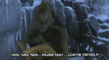 Movie gif. Jim Carrey as the Grinch from How the Grinch Stole Christmas reads from a book on his icy, windy mountaintop. As he speaks angrily, he makes a sweeping motion across the frame and closes his hand in a fist. Text, "Hate, hate, hate...double hate! Loathe entirely!"