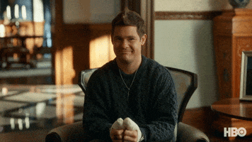 TV gif. With both of his thumbs in casts, a smiling Adam Devine as Kelvin in The Righteous Gemstones winks and holds up a hand, giving us a thumbs up.