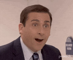 The Office gif. Actor Steve Carell as Michael in The Office hangs his mouth open in happy shock and is blown back by surprise.