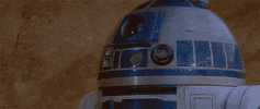 Star Wars gif. Closeup of R2D2's face and then we zoom out to see him fall forward and face plant on the ground. Text, "Dead."