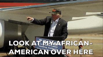 Political gif. Donald Trump stands in front of a podium at a rally and points over into the audience as he speaks into the microphone. He says, “Look at my African American over here.”