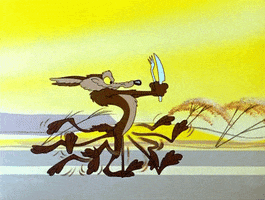 Cartoon gif. A hungry Wile E. Coyote from Looney Tunes runs with determination, holding a fork and knife in front of him.