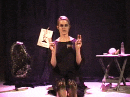 Video gif. A woman sitting on a stage surrounded by crystals bends the first two fingers on each hand and all 10 of her toes as she says, "define facts," skeptically. The phrase also appears as text.