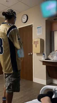 LA Rams Fan Can't Contain Excitement Over Super Bowl Victory While Holding Newborn