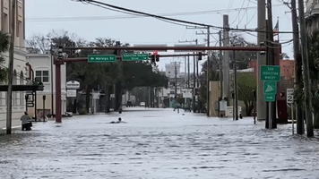 Surfer Paddles in Flooded Streets