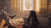 Music video gif. A scene from Taylor Swift's Lover music video. A family dressed in matching christmas pajamas all hug each other on christmas morning. 