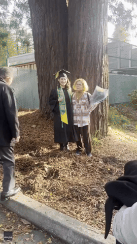 Girl Surprises Older Sister During Graduation Picture