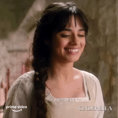 Movie gif. Camila Cabello as Cinderella in Cinderella smiles and claps enthusiastically. 
