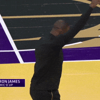 Sports gif. Lebron James in street clothes holds one fist up and the other at his low back as he thrusts his hips and jumps forward with each thrust. 