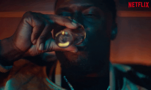 TV gif. Supercut of Kevin Hart as Kid in True Story and other cast members pouring drinks, downing drinks, and clinking glasses.