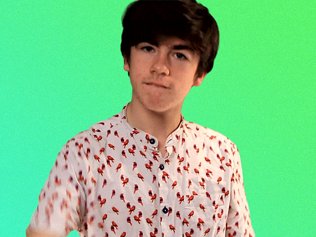 Celebrity gif. Declan McKenna looks at us with a serious expression, drops a mic, and turns away.