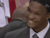 Video gif. Smiling man suddenly reacts with concern, then disappointment, frowning as if to say, “How could you?”