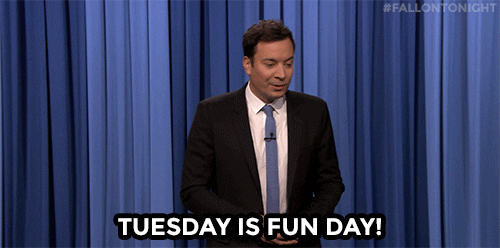 Tonight show gif. Jimmy Fallon stands in front of his blue curtain and says uncertainly, "Tuesday is a fun day!," which appears as text. He moves his arms up and down, as if he's weighing his options.